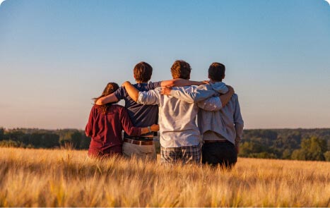 group of people embracing in a field